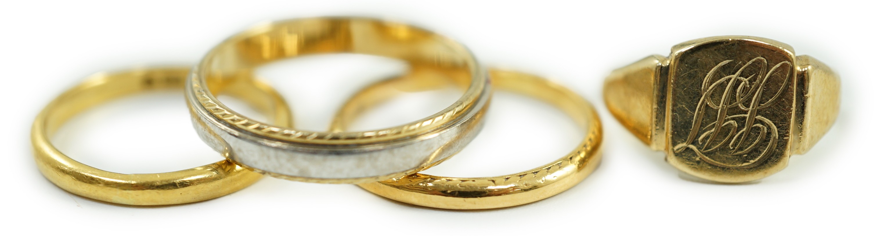 Two 22ct gold wedding bands, 5.2 grams, a 9ct gold signet ring, 2.4 grams and a two colour 750 yellow metal band, 4.4 grams.